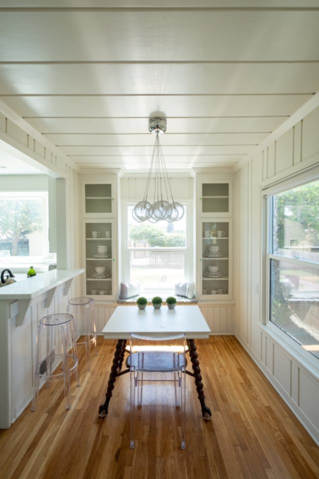 A bright, quiet kitchen with morning light coming through tall windows.